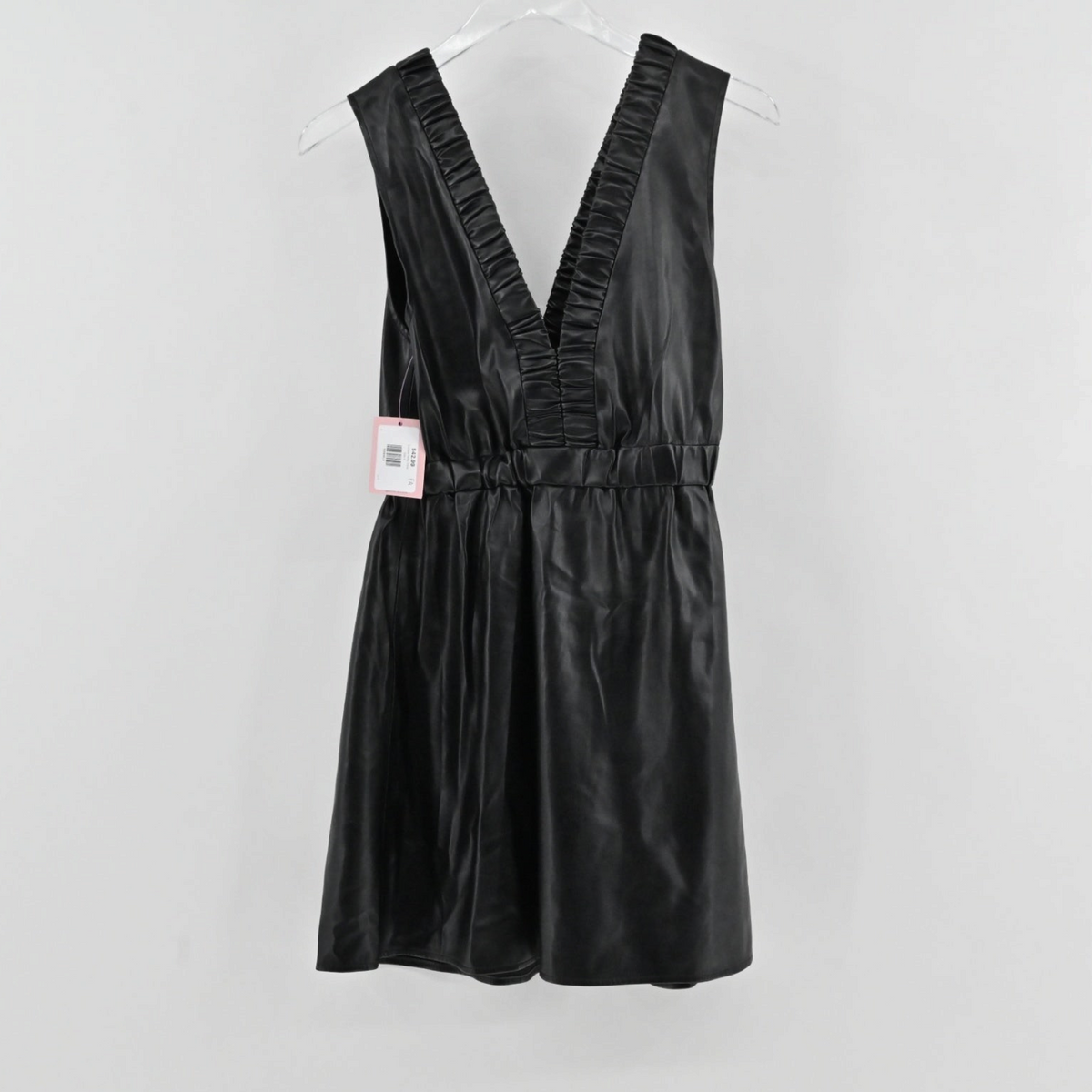 Lynn's Closet Boutique black faux leather mini dress with a deep V-neckline, ruffle trim, and elasticized waist.