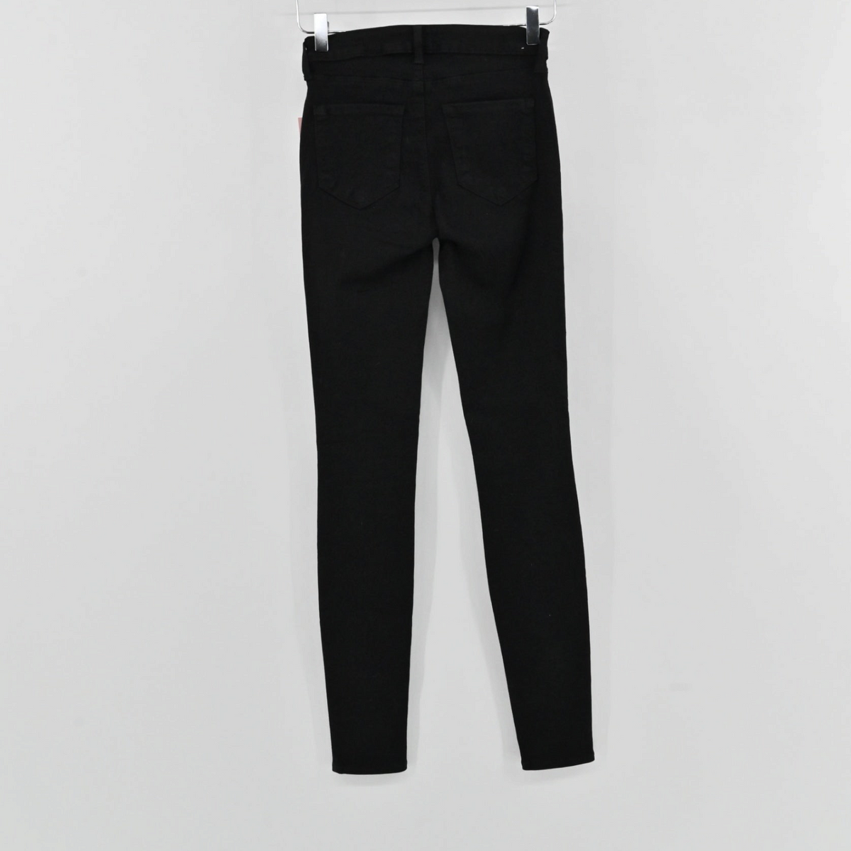 Lynn's Closet Boutique L'Agence Marguerite black skinny jeans hanging on a hanger, back view.
