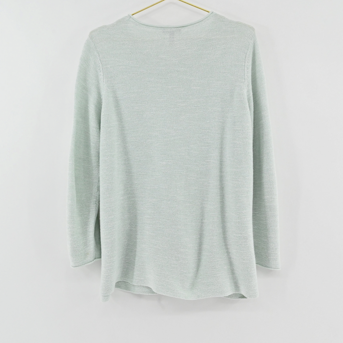 Lynn's Closet Boutique Eileen Fisher mint green textured crew neck sweater hanging on a gold hanger