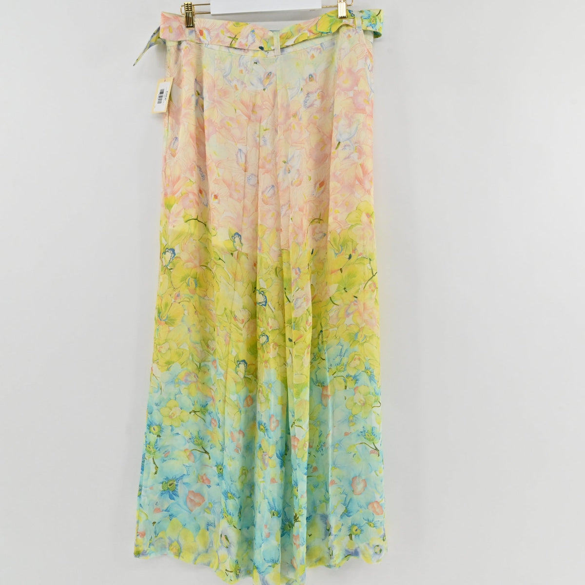 Lynn's Closet Boutique floral pleated wide-leg pants in a watercolor peach, yellow, and blue gradient print.