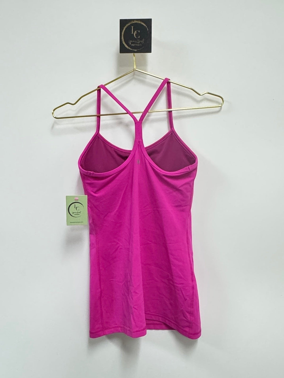 Lynn's Closet Boutique fuchsia Lululemon Power Y tank top with signature Y-back design hanging on a gold hanger.