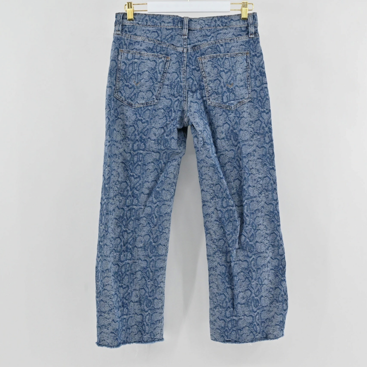 Lynn's Closet Boutique Hudson blue snakeskin print straight-leg jeans with a raw frayed hem, back view.