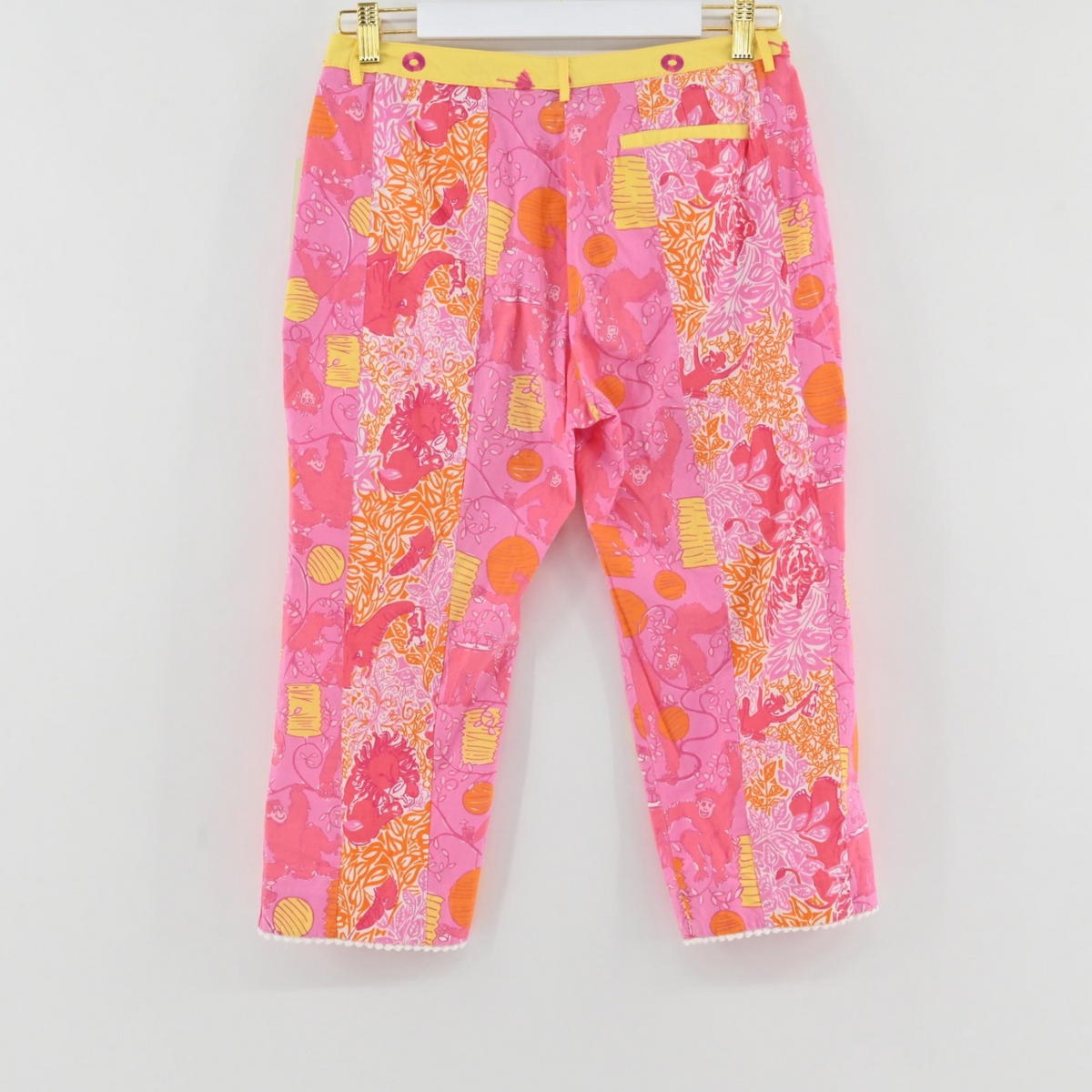 Lynn's Closet Boutique Lilly Pulitzer monkey print cropped pants in pink and orange with a yellow waistband.