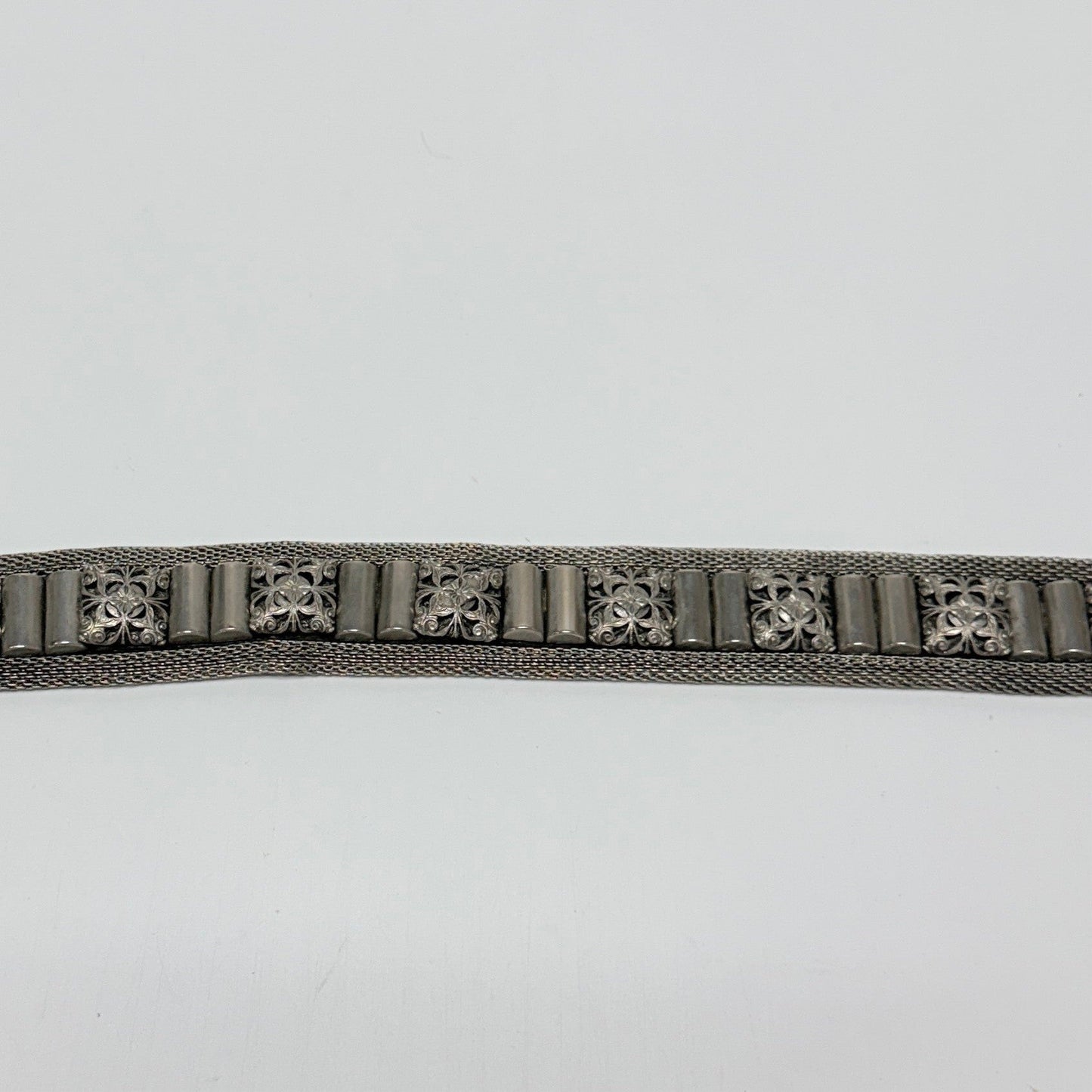 Lynn's Closet Boutique Nanni Italian metallic mesh belt with ornate engraved silver-tone hardware and decorative studs.