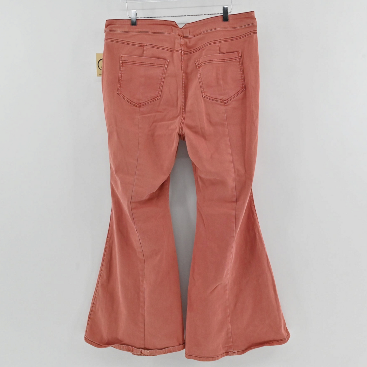 Lynn's Closet Boutique Free People terra cotta wide-leg flare pants with back pockets, shown from the back view.