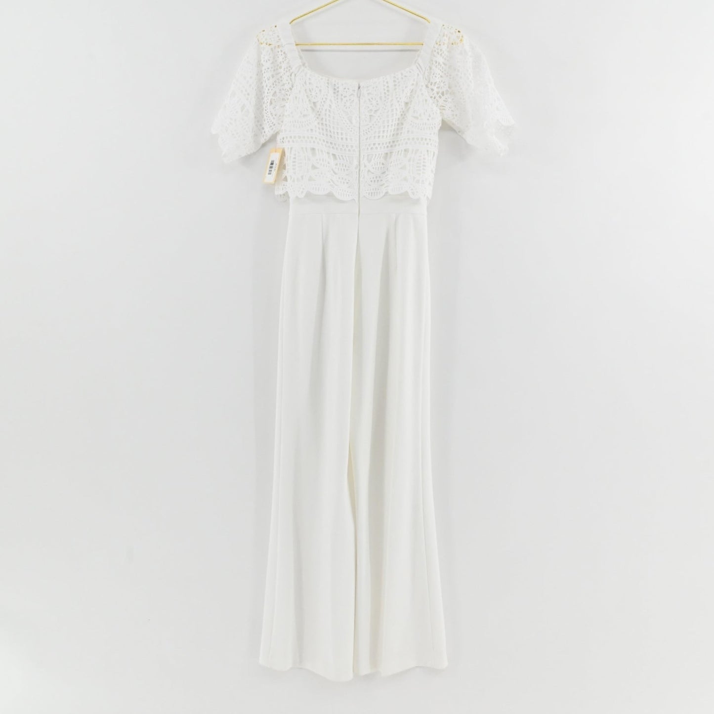Lynn's Closet Boutique Antonio Melani white jumpsuit with off-the-shoulder crochet lace bodice and wide-leg trousers.
