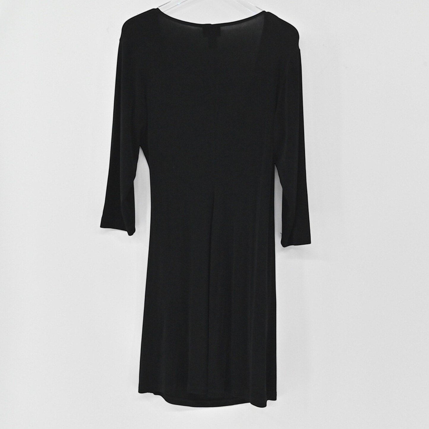 Lynn's Closet Boutique Chicos Travelers black faux wrap dress with three-quarter sleeves hanging against a white wall.
