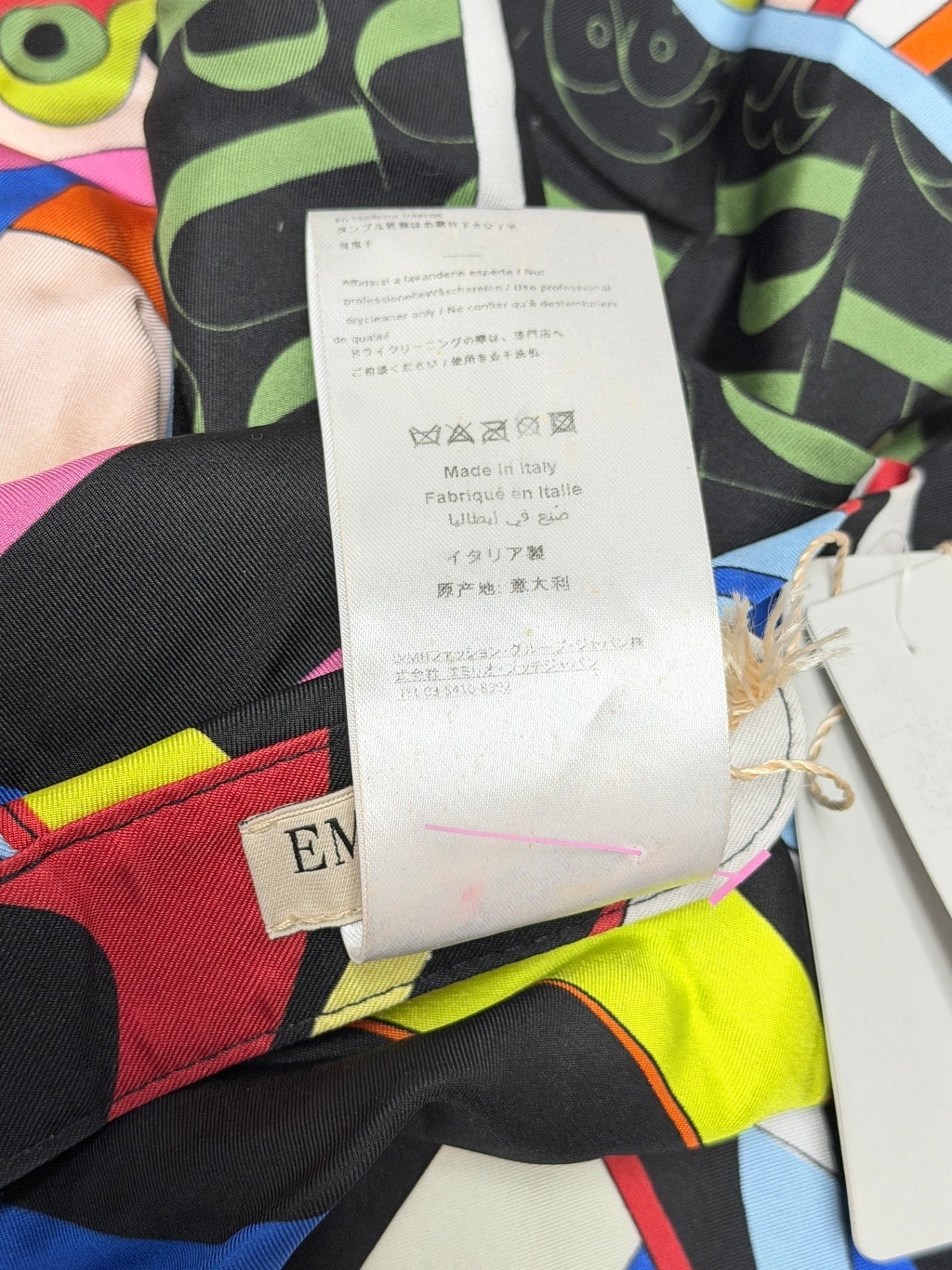 Lynn's Closet Boutique Emilio Pucci silk hat care label showing Made in Italy and brand tag on colorful silk fabric