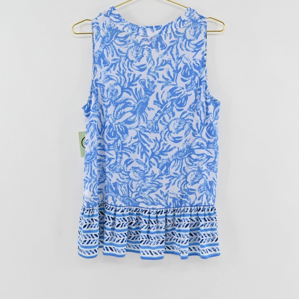 Lynn's Closet Boutique Lilly Pulitzer Gramercy sleeveless top in blue and white botanical print with a ruffled hem.