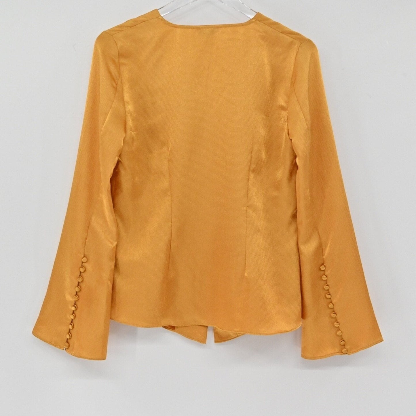 Lynn's Closet Boutique golden-mustard silky bell sleeve top with button cuff details, back view.
