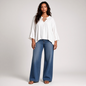Model wearing a white Kobi Halperin tie blouse with three-quarter sleeves and blue jeans from Lynn's Closet Boutique.