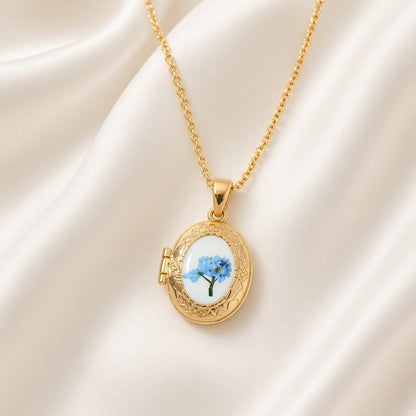 Pressed Flower Locket Pendant Necklace Gold Tone Copper - Framed Blue Flower Oval close-up