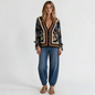 Model wearing Lynn's Closet Boutique Free People bohemian print V-neck top with tie sleeves and blue jeans