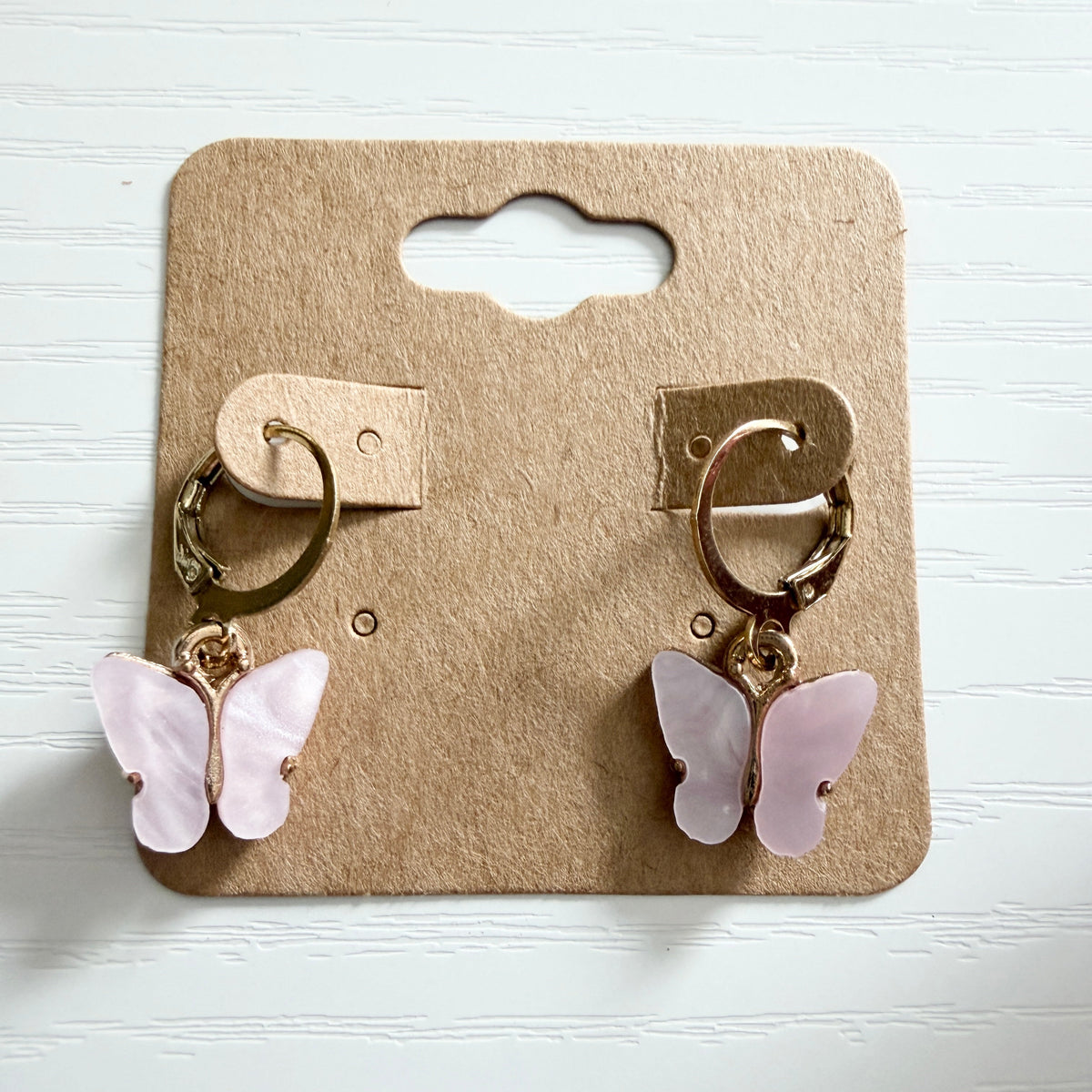 Gold huggie earrings with pink butterfly drop