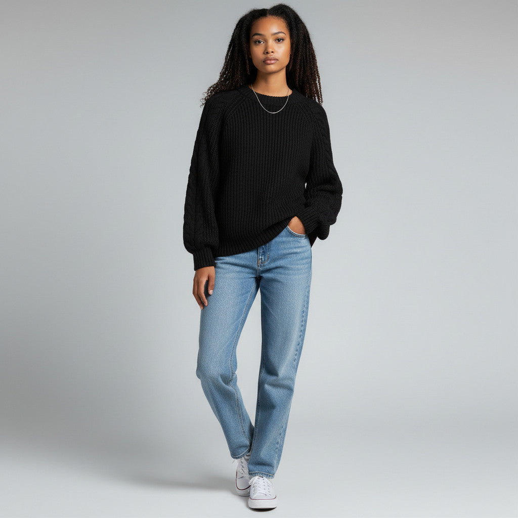 Model wearing a black 525 America ribbed sweater with blue jeans from Lynn's Closet Boutique