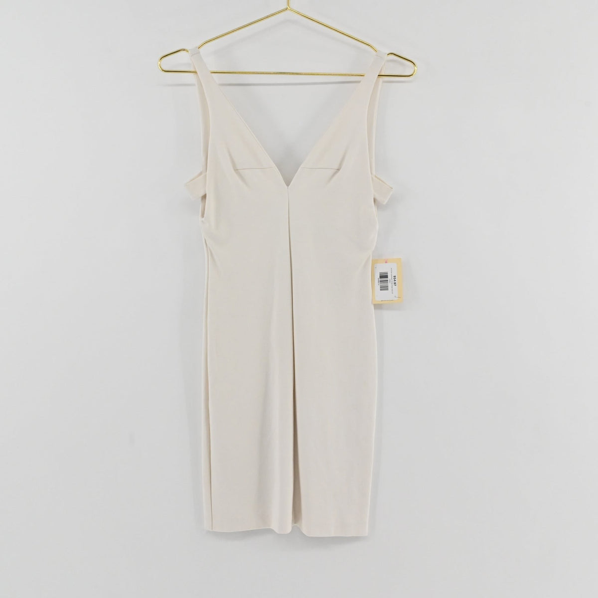 Lynn's Closet Boutique Amanda Uprichard white mini dress with deep V-neck and cold-shoulder detail on a gold hanger.