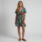 Model wearing a Lynn's Closet Boutique Anthropologie navy floral mini dress with flutter sleeves and a tiered skirt.