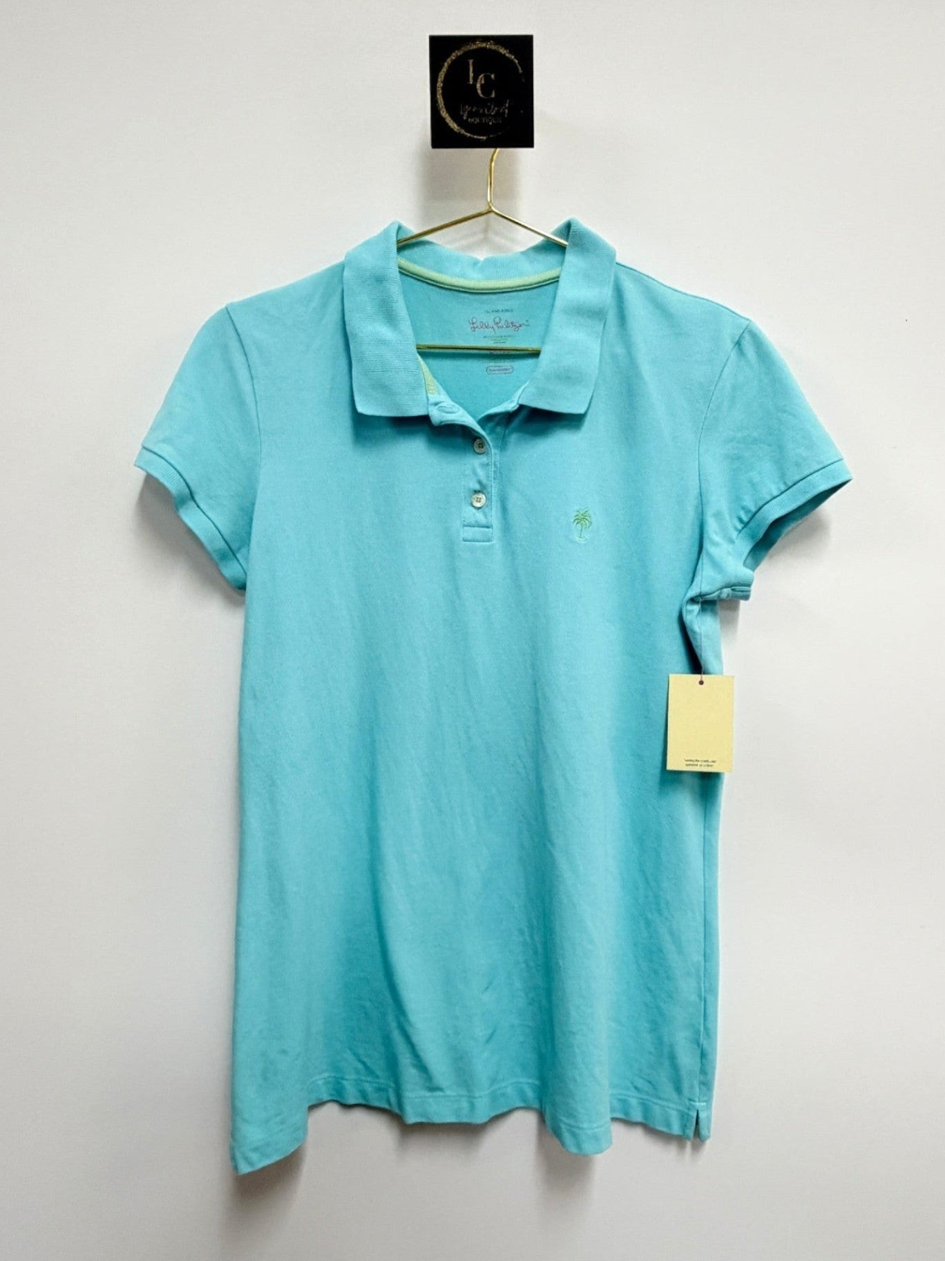 Lynn's Closet Boutique aqua Lilly Pulitzer polo shirt with a small embroidered palm tree logo and button placket.