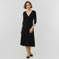 Model wearing a black BCBGMaxAzria wrap dress with three-quarter sleeves and a buckle waist from Lynn's Closet Boutique