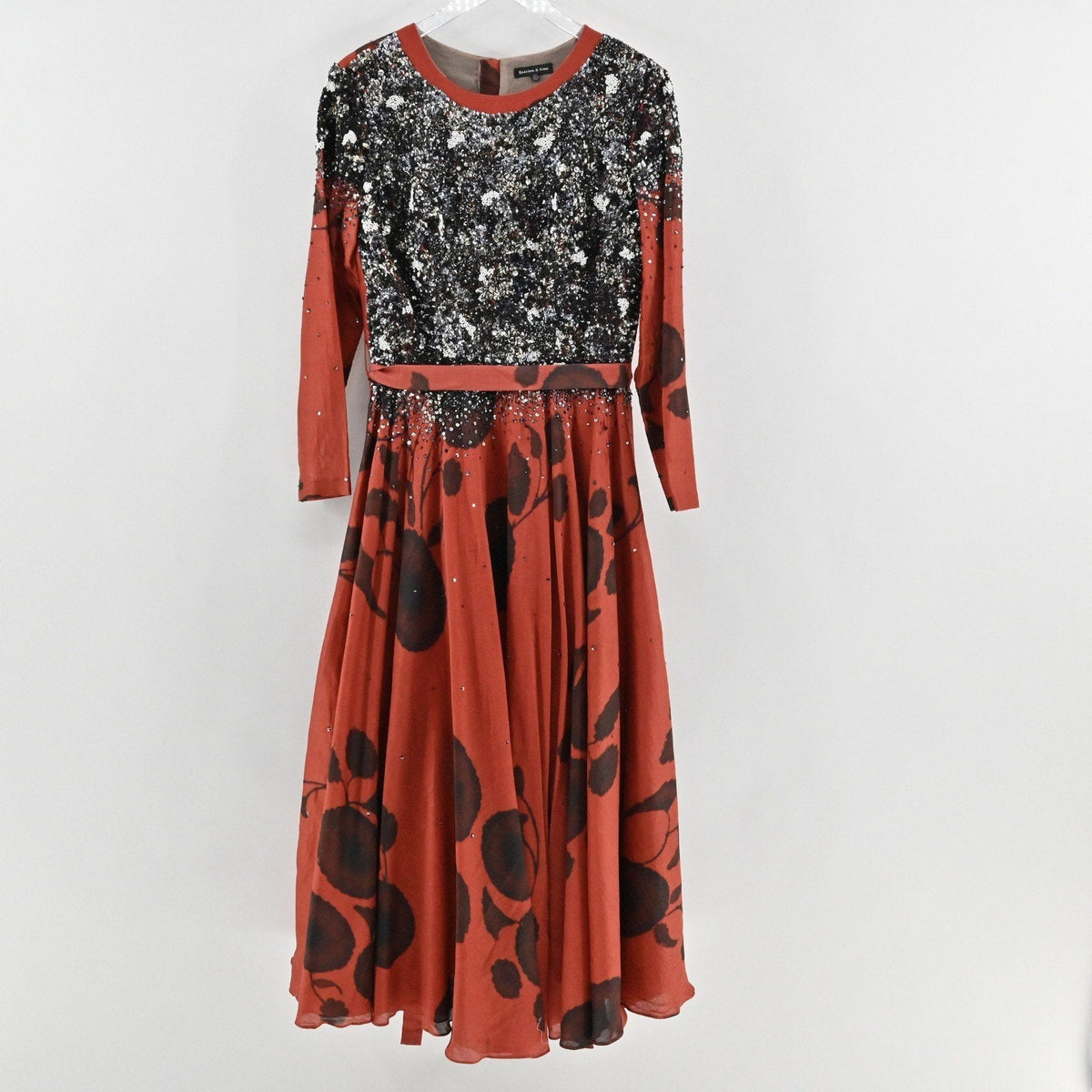 Lynn's Closet Boutique Saaksha Kinni rust and black floral maxi dress with beaded sequin bodice and long sleeves.