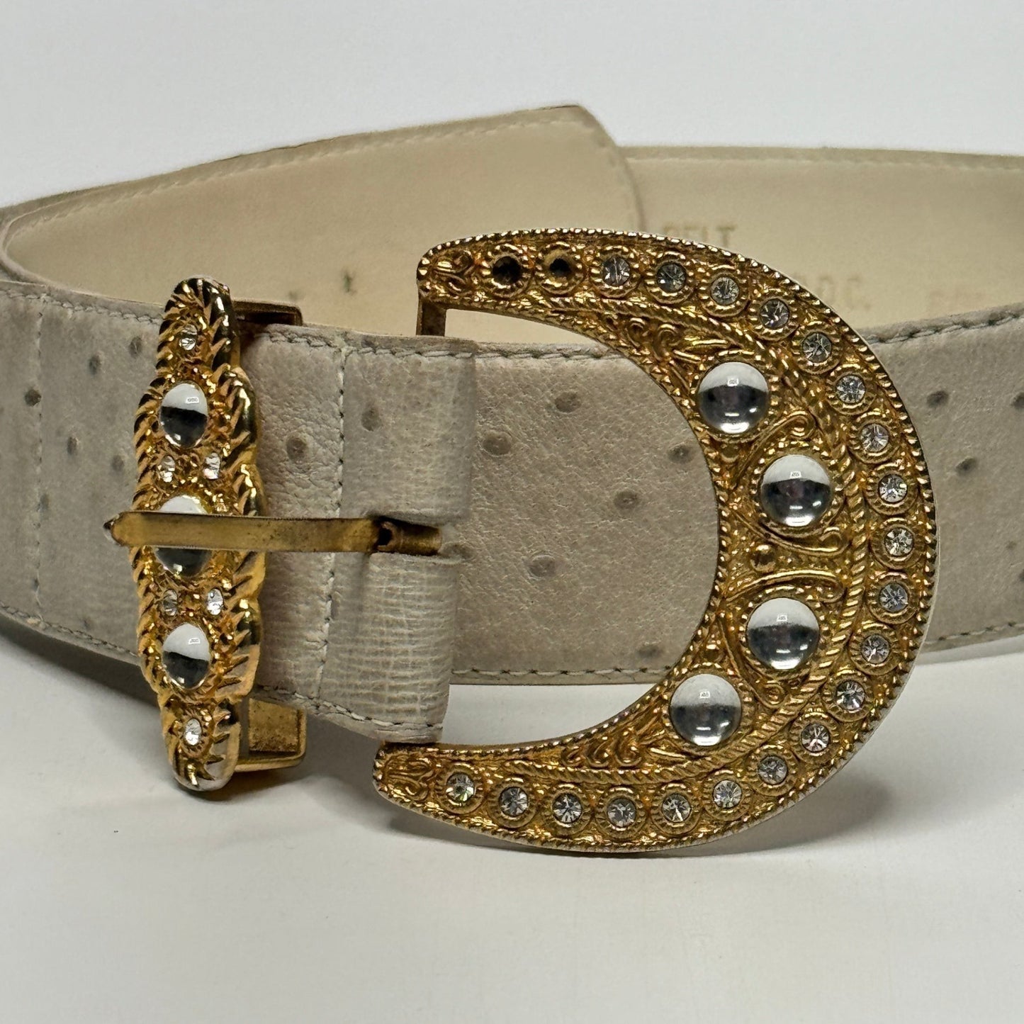 Lynn's Closet Boutique vintage beige ostrich-embossed belt with a gold crescent buckle and clear crystal accents.