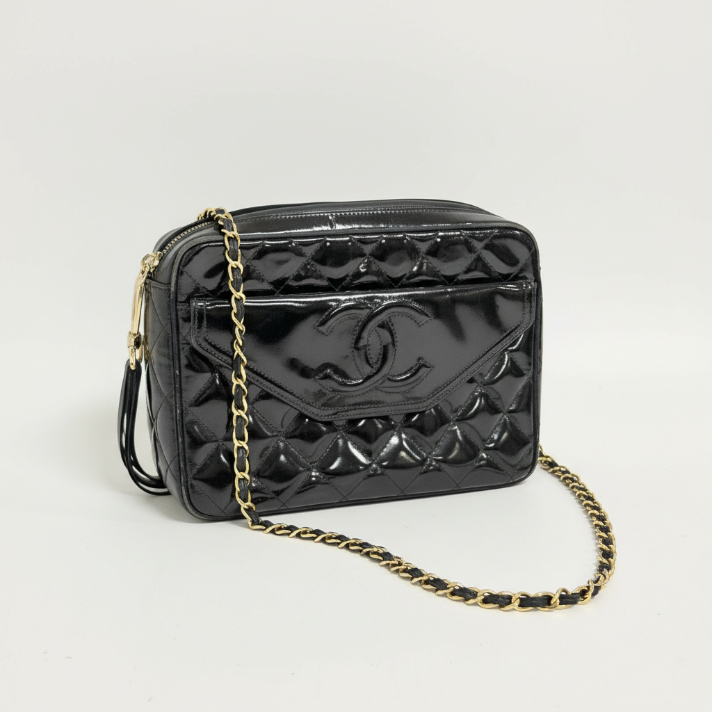 Lynn's Closet Boutique black quilted patent leather Chanel camera bag with gold chain strap and CC logo