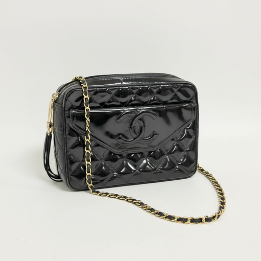 Lynn's Closet Boutique black quilted patent leather Chanel camera bag with gold chain strap and CC logo