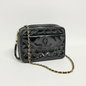 Lynn's Closet Boutique black quilted patent leather Chanel camera bag with gold chain strap and CC logo
