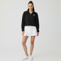 Lynn's Closet Boutique model wearing a black The North Face cropped quarter-zip fleece with a white tennis skirt.