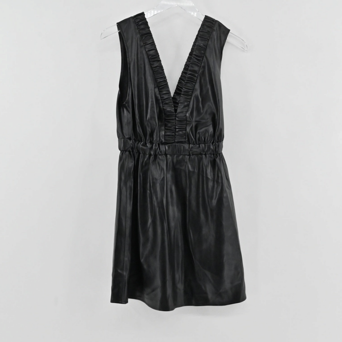 Lynn's Closet Boutique black faux leather mini dress with a deep V-neckline, ruffle trim, and elasticized waist.