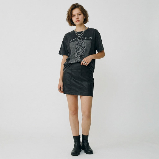 Lynn's Closet Boutique Free People black faux leather mini skirt worn by a model with a graphic tee and ankle boots.
