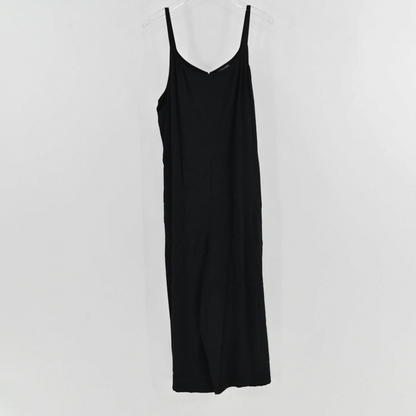 Lynn's Closet Boutique Eileen Fisher black sleeveless jumpsuit with a V-neckline and spaghetti straps on a hanger.