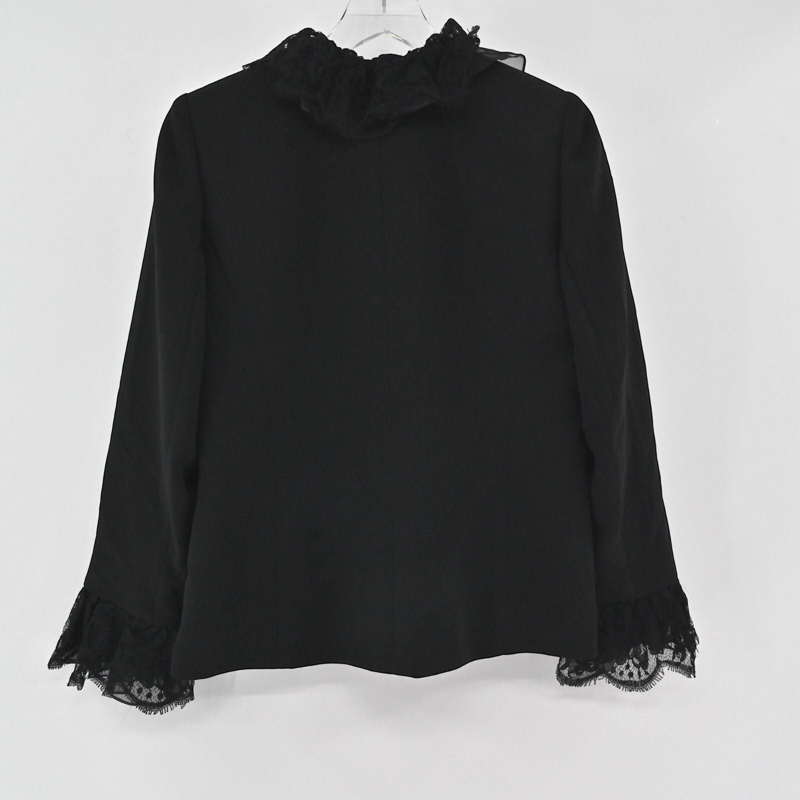 Lynn's Closet Boutique black Nina Raynor jacket featuring a ruffled lace collar and lace-trimmed cuffs, back view.