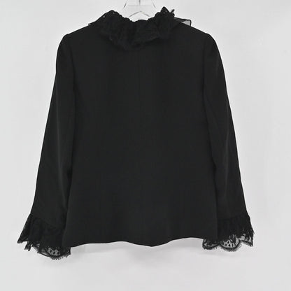 Lynn's Closet Boutique black Nina Raynor jacket featuring a ruffled lace collar and lace-trimmed cuffs, back view.