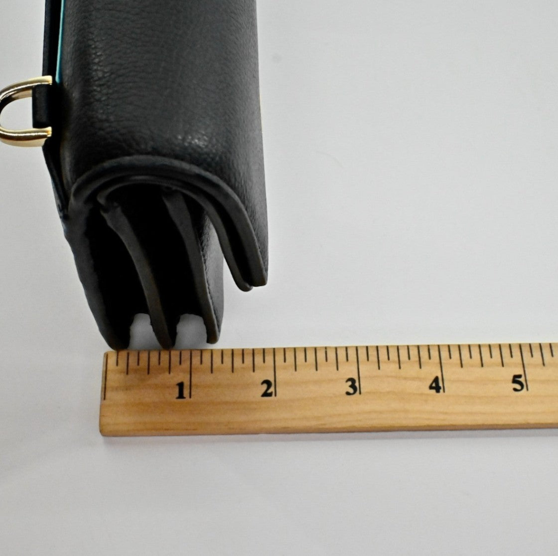 Lynn's Closet Boutique Kate Spade black pebbled leather crossbody bag side profile showing depth with a ruler.