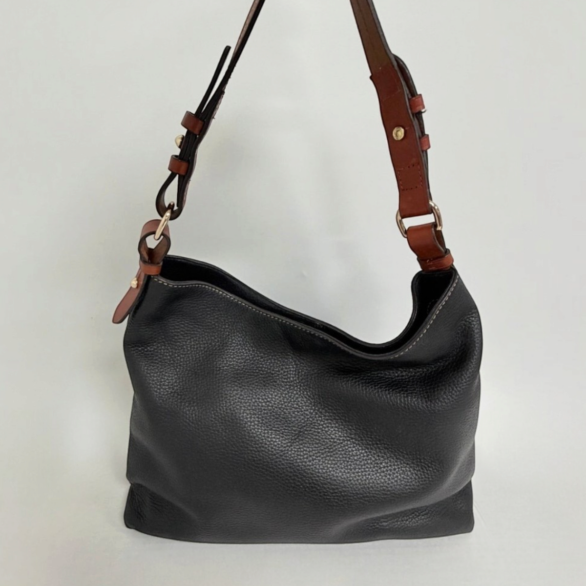 Lynn's Closet Boutique Dooney & Bourke black pebbled leather tote with brown leather shoulder strap and gold hardware.