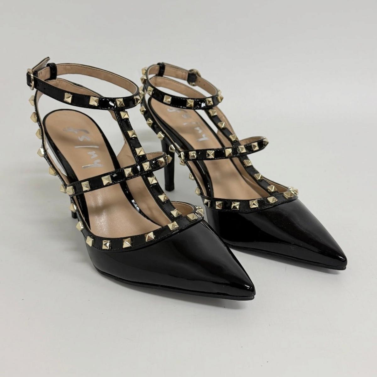 Lynn's Closet Boutique FS/NY black patent pointed-toe heels with gold pyramid studs and multi-strap cage design.