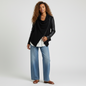 Model wearing a Lynn's Closet Boutique Blank NYC black faux leather moto jacket with an asymmetrical draped front.