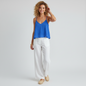 Model wearing a blue textured Lilly Pulitzer Aletta Top with white linen trousers from Lynn's Closet Boutique