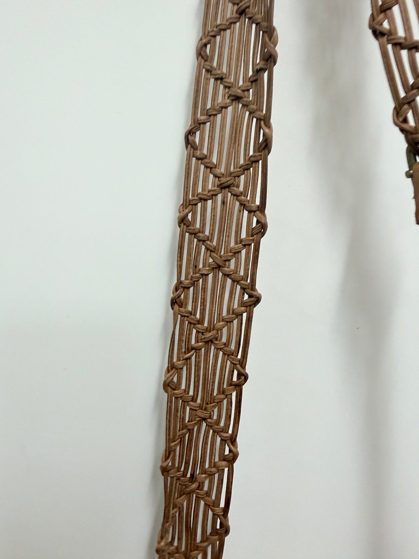 Lynn's Closet Boutique brown leather crossbody bag featuring a detailed bohemian braided strap design