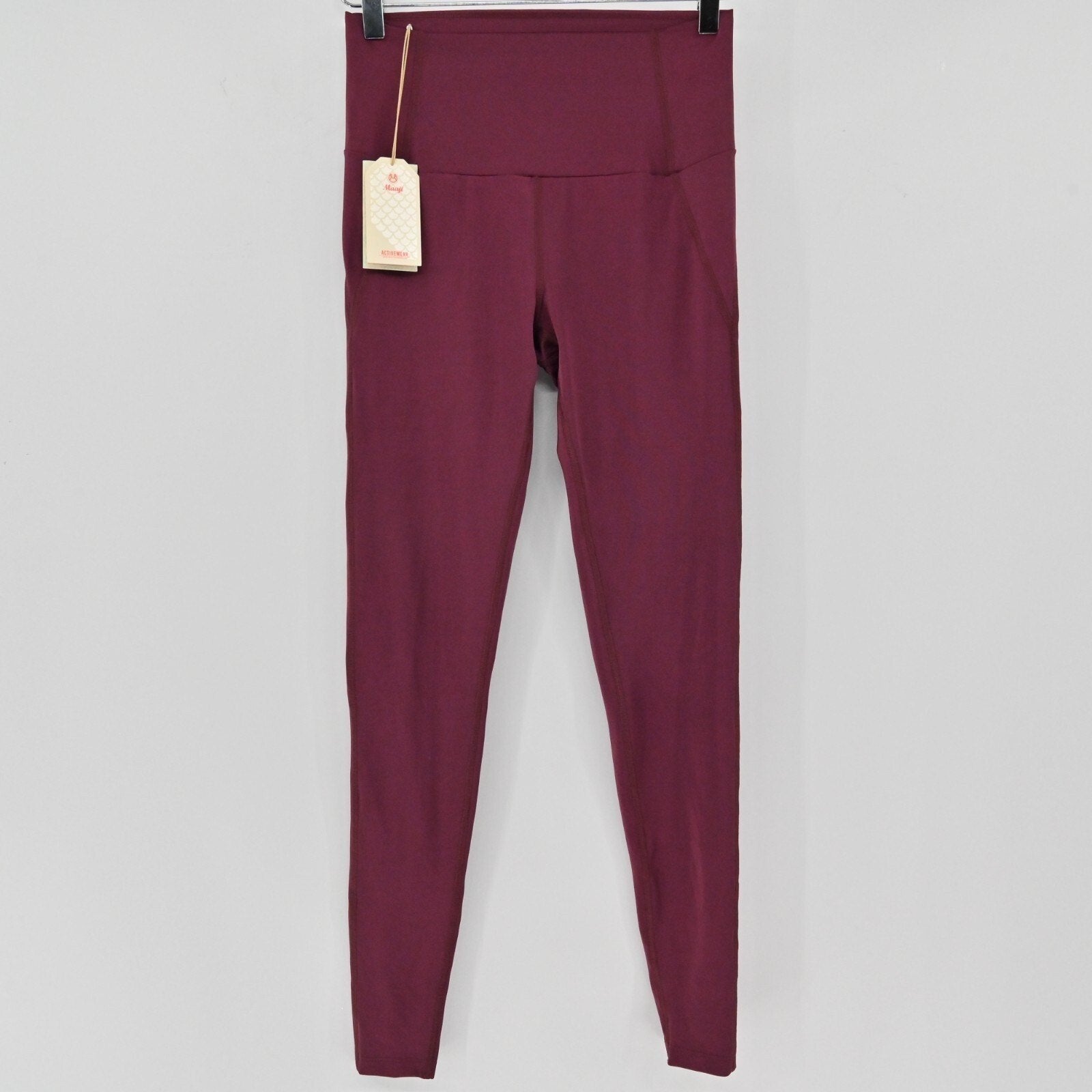 Lynn's Closet Boutique Maaji Vienna high-waisted burgundy leggings with moisture-wicking fabric and brand tags.