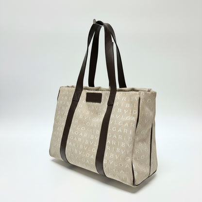 Lynn's Closet Boutique Bvlgari Logomania beige canvas tote bag with brown leather handles and logo print pattern.