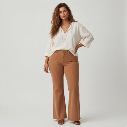 Model wearing Lynn's Closet Boutique Free People camel corduroy flared pants with vertical seams and a white blouse.