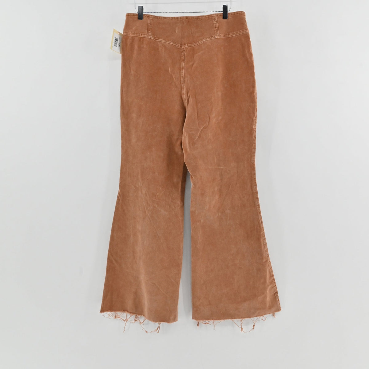 Lynn's Closet Boutique camel corduroy flared pants with high-rise waist and raw frayed hem, back view.