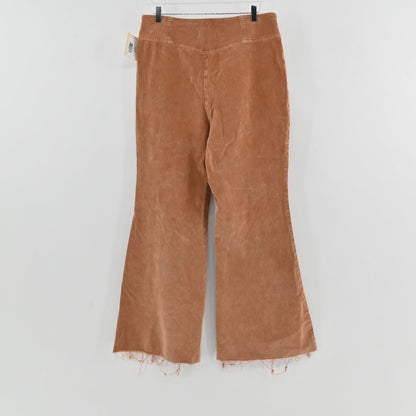 Lynn's Closet Boutique camel corduroy flared pants with high-rise waist and raw frayed hem, back view.
