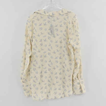 Lynn's Closet Boutique Catherine Gee long-sleeve blouse in cream with a grey origami crane print and button cuffs.