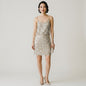Model wearing a Lynn's Closet Boutique Anthropologie Verb champagne sequin mini dress with spaghetti straps