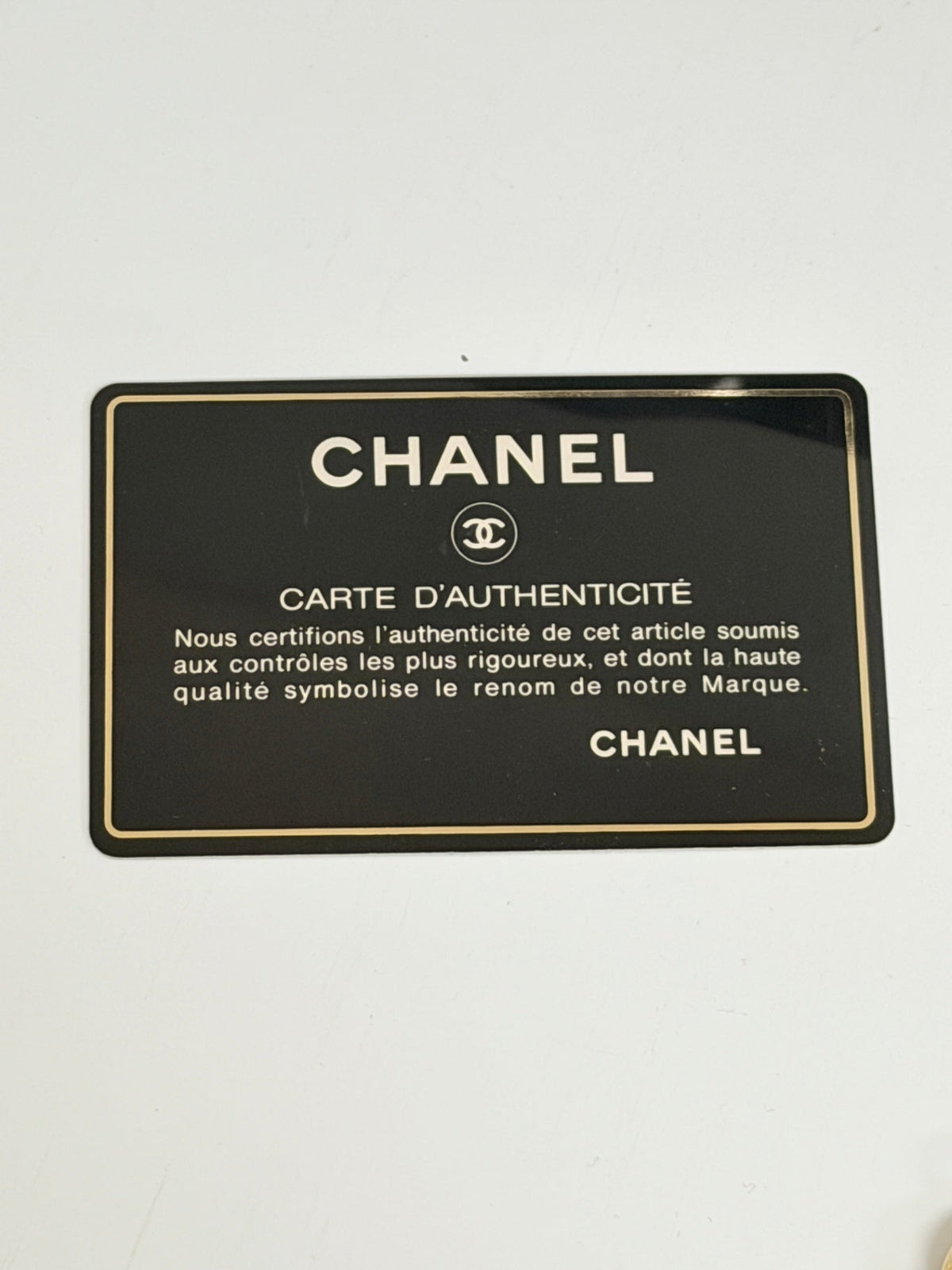 Lynn's Closet Boutique Chanel authenticity card with black background and gold lettering for a vintage camera bag
