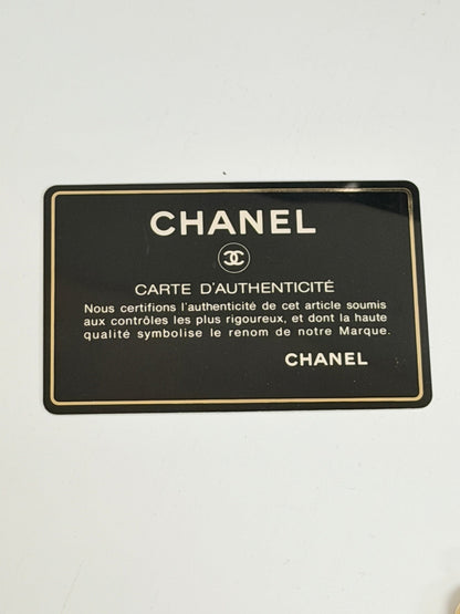 Lynn's Closet Boutique Chanel authenticity card with black background and gold lettering for a vintage camera bag