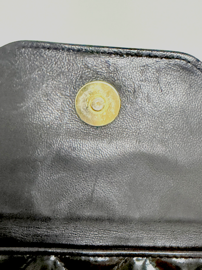 Lynn's Closet Boutique Chanel camera bag interior featuring a gold-tone magnetic snap closure on black leather